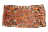 Vintage Oushak rug runner with a rust field, central pinwheel medallion, and eggplant geometric motifs.