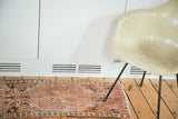 Left side of vintage Oushak rug showing pinwheel medallion with serpents, floral motifs, multicolored selvedge.