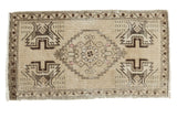 Vintage Oushak distressed rug with beige field, dark geometric medallion, 1'9