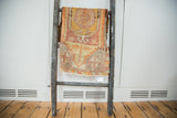 Distressed vintage Oushak rug runner featuring a faded geometric medallion in saffron and cranberry.