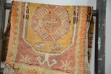 Vintage Oushak rug's distressed textural pile, with saffron yellow and faded cranberry tones.