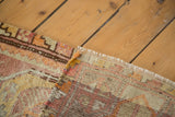 Vintage Oushak rug showing hand-knotted foundation, fringed edge, and distressed pile.