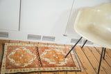Plush thick pile with tangerine orange medallions on a faded cinnabar Oushak rug.
