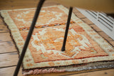 Thick, plush pile of vintage Oushak rug with tangerine medallions and cinnabar field.
