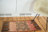 Angled vintage Oushak rug view, crab medallion with serrated motifs in terracotta, orange, brown.