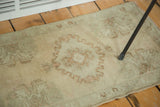 Vintage Oushak rug pile texture with expressive scrolling medallion and terra cotta motif.