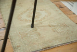 Faded germinating planter motif on ivory and blush field of vintage Oushak rug.