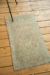 Vintage Oushak rug's secured side edge and bottom fringe with faded peach tones.