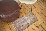 Vintage Oushak rug with asymmetric serrated medallion, mauve field, and germinating planter motifs.