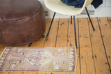 Corner detail of Vintage Oushak rug, showing geometric pattern, fringe, and side selvedge.