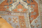 Hand-knotted foundation and vivid comb feather pattern on a vintage Oushak corner.