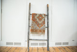 Vintage Oushak mat with rust quatrefoil medallion, comb feather motifs, slate grey field.