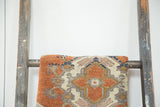 Vintage Oushak rug close-up showing rust quatrefoil, stepped outlines, and slate blue motifs.