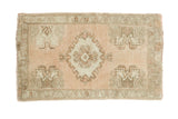 Vintage Oushak rug features blush field, scrolling medallion, and germinating flower corner motifs, 1'8