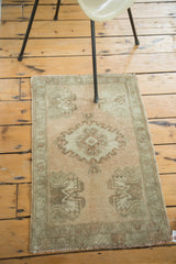 Vintage Oushak rug's lower-left corner, featuring germinating flower motif and faded sea foam green.