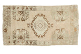 Vintage hand-knotted Oushak rug mat with oblong medallion, planter motifs, and muted tones.
