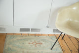Vintage Oushak rug with serrated zigzag medallion in mint green and copper tones.