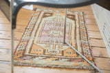 Vintage Oushak rug corner, faded violet and orange geometric border, multicolor selvedge.