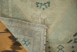 Hand-knotted foundation, intact side selvedge, and secured end of a vintage Oushak rug.