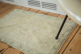 Vintage Oushak rug's faded pistachio green pile texture and intact side selvage.