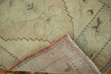 Secured burnt orange selvedge and hand-knotted back of the Turkish Oushak rug.