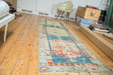Distressed antique Persian runner with faded aqua field and large red medallions.