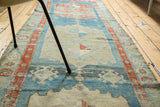 Distressed aqua blue, rust, and beige geometric border and medallion field of antique Persian runner.
