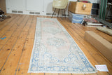 Distressed hand-knotted vintage Oushak runner with triple aqua blue medallions and pale blush field.