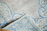 Hand-knotted construction and distressed pile of vintage Turkish Oushak, blush and aqua.