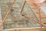 Faded chocolate, beige, and plum floral medallions with geometric border.
