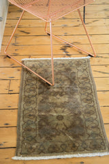 Faded plum and chocolate brown floral pattern, bubbly geometric border, and white fringe.