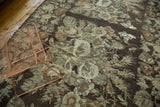 Earthen green and wooded brown vintage Turkish Kilim with stylized European rose and leaf pattern.