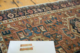 Faded brick red, blue geometric pattern on hand-knotted Karaja rug pile, mostly even wear.