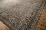 Intricate floral border detail on Antique Distressed Khorassan rug, with exposed foundation.