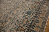 Faded rust, blue, and ivory floral border, distressed pile with exposed foundation.