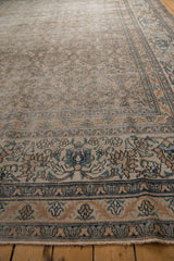 Distressed antique Khorassan carpet detail: exposed foundation, intricate faded blue, rust, ivory border.