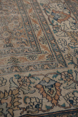 Heavily distressed antique Khorassan carpet with exposed foundation, faded rust, blue, ivory motifs.