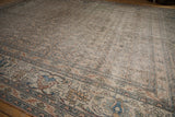 Faded intricate floral pattern and distressed texture of the antique Khorassan rug.