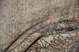 Distressed texture with exposed foundation, intricate faded blue, rust, and ivory patterns.