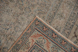 Heavy distress and exposed foundation of Antique Khorassan carpet corner with faded rust and blue.