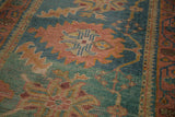 Hand-knotted Turkish Oushak runner with rosy rust and aqua floral field detail.