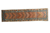 Antique Heriz runner, brick red geometric arrowhead field and sky blue patterned borders.