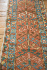 Antique Heriz runner showcasing a geometric arrowhead design with brick red, sky blue, and celadon.