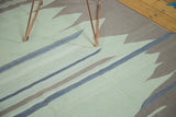 Abstract Kilim carpet texture showcasing muted sea foam green, natural grey, and sky blue stripes.