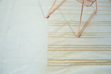 Hand woven Kilim patchwork showing plain ivory field alongside banded stripes.