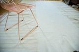 Vintage hand woven Turkish kilim patchwork, merging plain ivory with beige banded stripes.