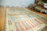 Hand woven Kilim rug displaying geometric multi-paneled style with winding motifs in sky blue.