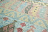 Multi-paneled geometric Kilim carpet with winding river motif in sky blue, pale cranberry.