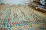 Abrashed geometric patterns in blue, yellow, and red on the hand-woven kilim.