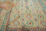 Pakistani Kilim carpet detail, showing geometric banded medallions in abrashed blue, red, yellow.